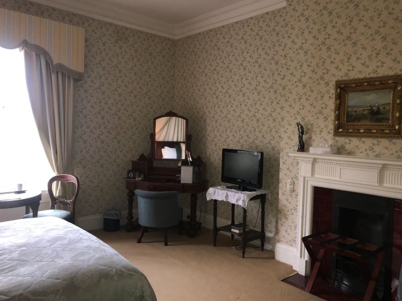 The fireplace and wallpaper add to this manor's charm at Dunbrody House.